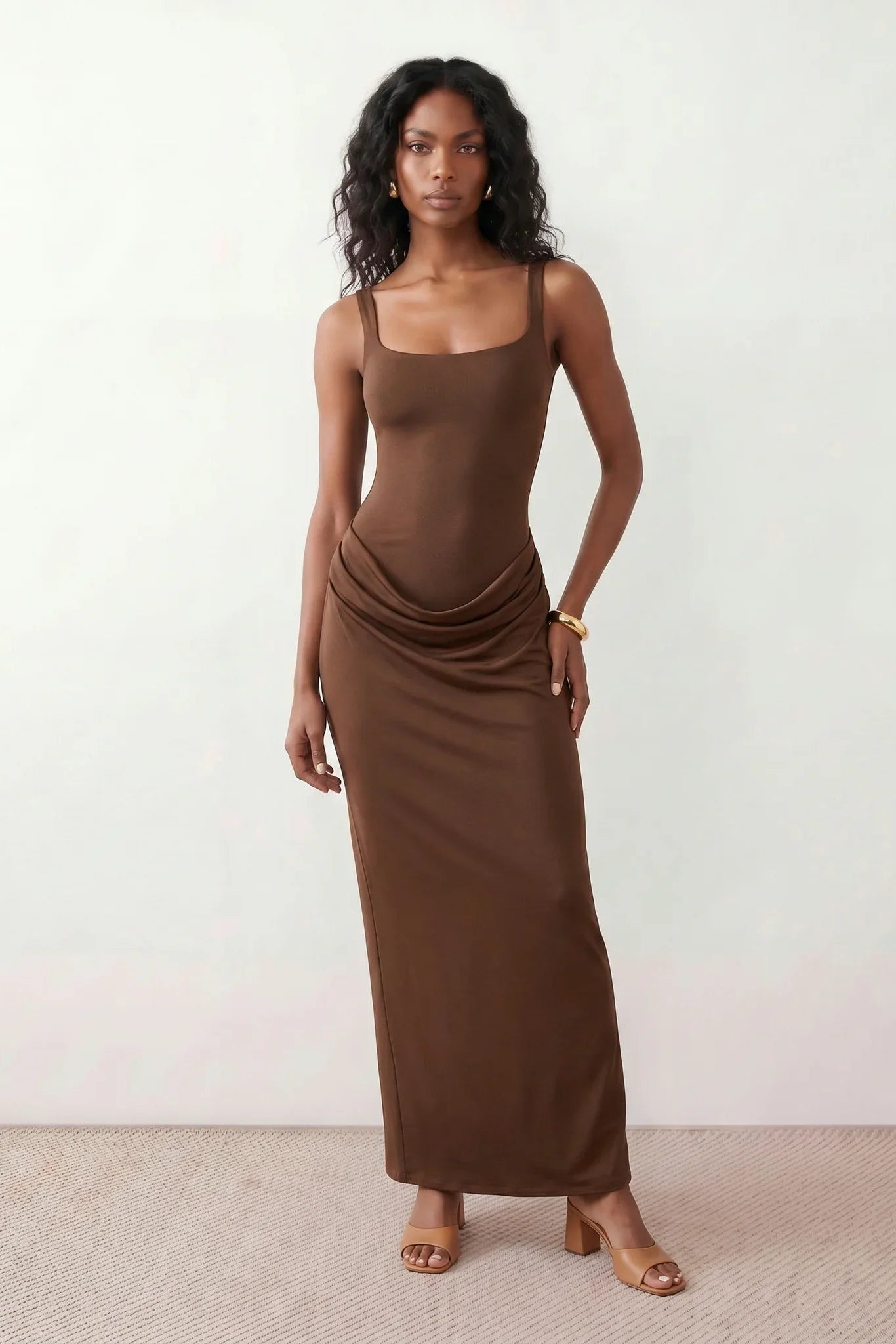 Women's Justina basque waist corset maxi dress featuring a structured boned bodice, square neckline, adjustable wide straps, ruched hip draping, side split, and a fitted floor-length silhouette for elegant evening and occasion wear.