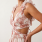 Woman wearing the Giedre Lace-Up A-Line Midi Dress featuring a deep V-neckline, ruffle shoulder sleeves, side waist cut-outs, adjustable lace-up open back and a flowing A-line midi skirt, ideal for weddings, race days and special occasions.