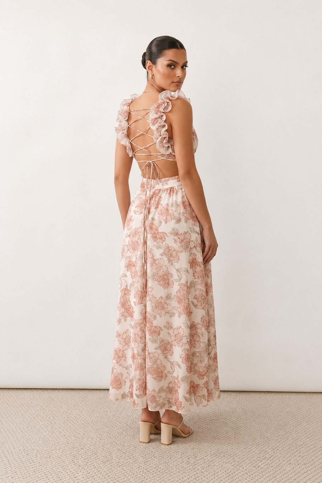 Woman wearing the Giedre Lace-Up A-Line Midi Dress featuring a deep V-neckline, ruffle shoulder sleeves, side waist cut-outs, adjustable lace-up open back and a flowing A-line midi skirt, ideal for weddings, race days and special occasions.
