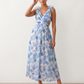 Woman wearing the Giedre Lace-Up A-Line Midi Dress featuring a deep V-neckline, ruffle shoulder sleeves, side waist cut-outs, adjustable lace-up open back and a flowing A-line midi skirt, ideal for weddings, race days and special occasions.