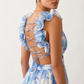 Woman wearing the Giedre Lace-Up A-Line Midi Dress featuring a deep V-neckline, ruffle shoulder sleeves, side waist cut-outs, adjustable lace-up open back and a flowing A-line midi skirt, ideal for weddings, race days and special occasions.