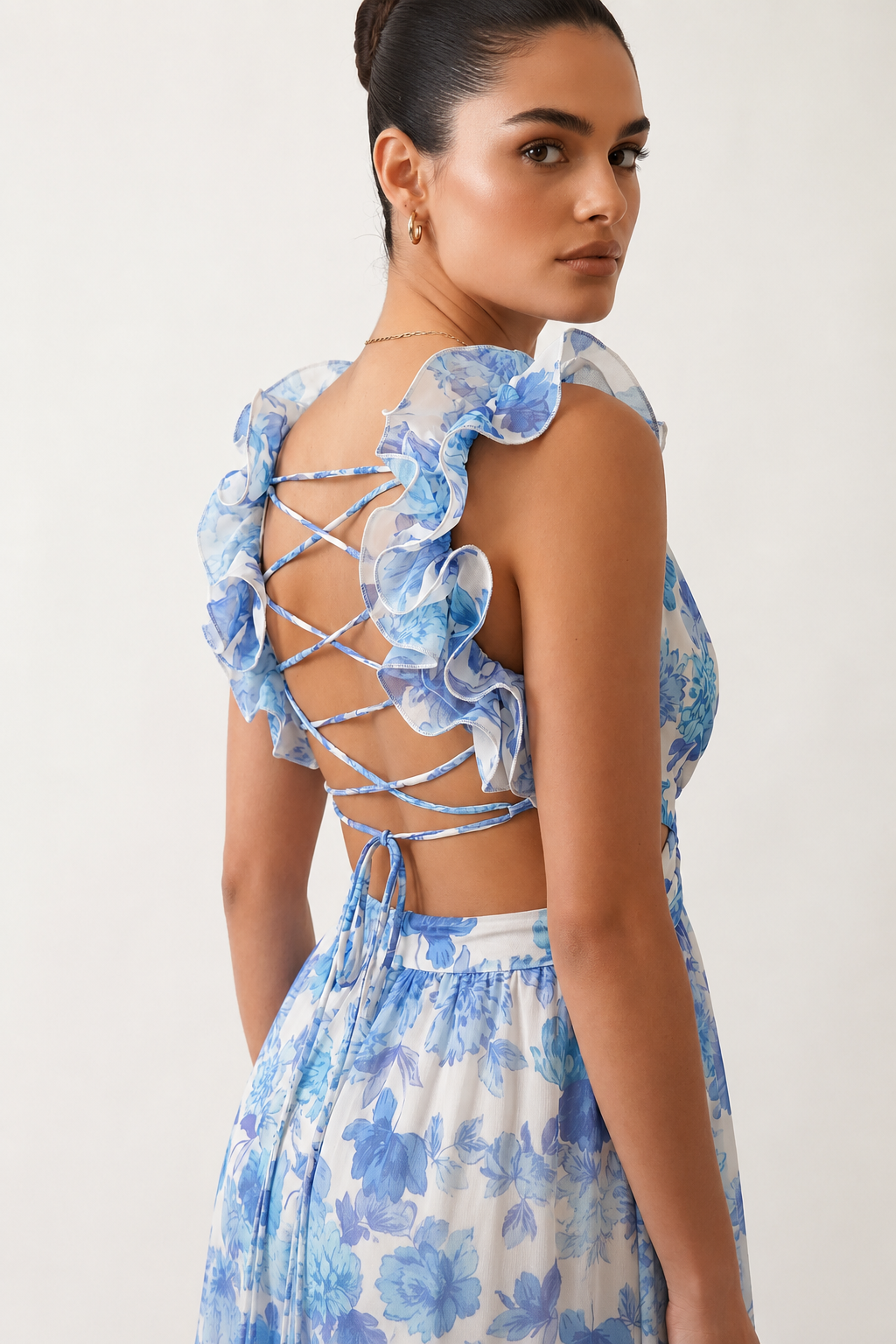 Woman wearing the Giedre Lace-Up A-Line Midi Dress featuring a deep V-neckline, ruffle shoulder sleeves, side waist cut-outs, adjustable lace-up open back and a flowing A-line midi skirt, ideal for weddings, race days and special occasions.