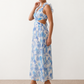 Woman wearing the Giedre Lace-Up A-Line Midi Dress featuring a deep V-neckline, ruffle shoulder sleeves, side waist cut-outs, adjustable lace-up open back and a flowing A-line midi skirt, ideal for weddings, race days and special occasions.