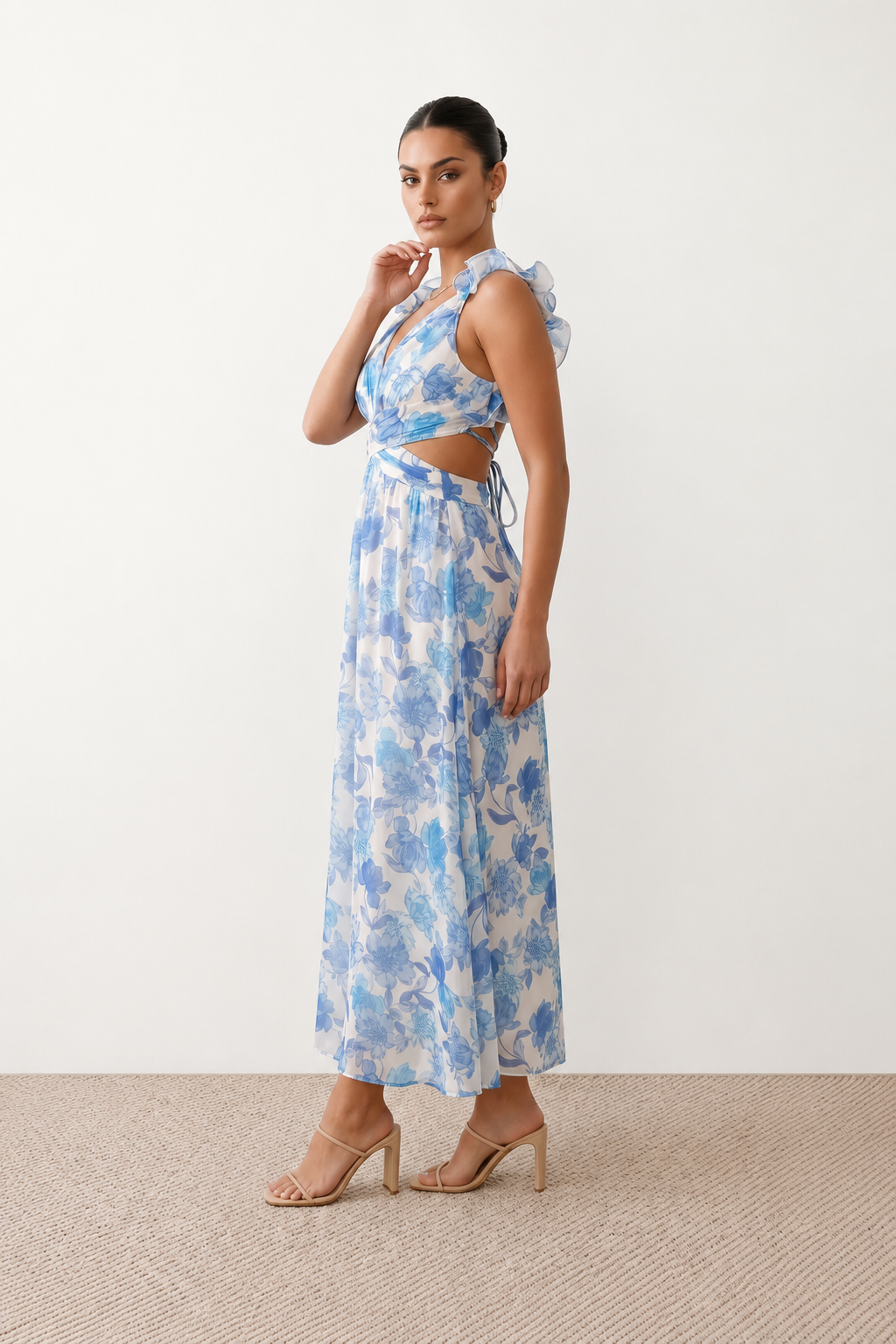 Woman wearing the Giedre Lace-Up A-Line Midi Dress featuring a deep V-neckline, ruffle shoulder sleeves, side waist cut-outs, adjustable lace-up open back and a flowing A-line midi skirt, ideal for weddings, race days and special occasions.