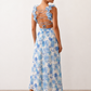 Woman wearing the Giedre Lace-Up A-Line Midi Dress featuring a deep V-neckline, ruffle shoulder sleeves, side waist cut-outs, adjustable lace-up open back and a flowing A-line midi skirt, ideal for weddings, race days and special occasions.