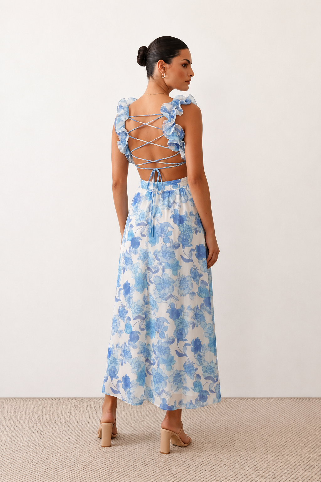 Woman wearing the Giedre Lace-Up A-Line Midi Dress featuring a deep V-neckline, ruffle shoulder sleeves, side waist cut-outs, adjustable lace-up open back and a flowing A-line midi skirt, ideal for weddings, race days and special occasions.
