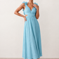 Woman wearing the Giedre Lace-Up A-Line Midi Dress featuring a deep V-neckline, ruffle shoulder sleeves, side waist cut-outs, adjustable lace-up open back and a flowing A-line midi skirt, ideal for weddings, race days and special occasions.