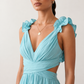 Woman wearing the Giedre Lace-Up A-Line Midi Dress featuring a deep V-neckline, ruffle shoulder sleeves, side waist cut-outs, adjustable lace-up open back and a flowing A-line midi skirt, ideal for weddings, race days and special occasions.