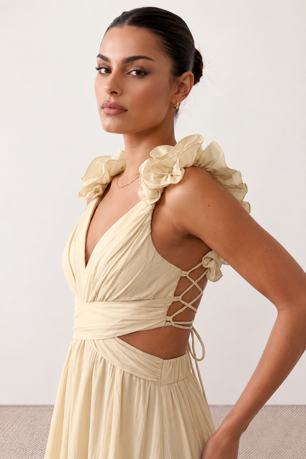 Woman wearing the Giedre Lace-Up A-Line Midi Dress featuring a deep V-neckline, ruffle shoulder sleeves, side waist cut-outs, adjustable lace-up open back and a flowing A-line midi skirt, ideal for weddings, race days and special occasions.