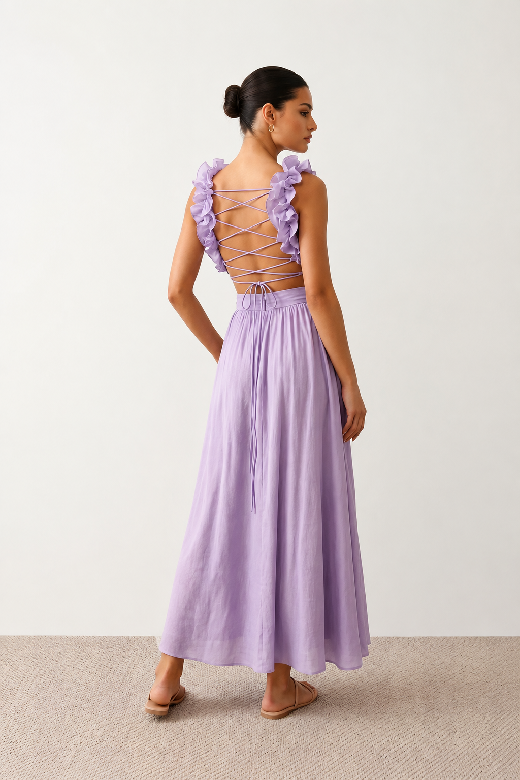 Woman wearing the Giedre Lace-Up A-Line Midi Dress featuring a deep V-neckline, ruffle shoulder sleeves, side waist cut-outs, adjustable lace-up open back and a flowing A-line midi skirt, ideal for weddings, race days and special occasions.