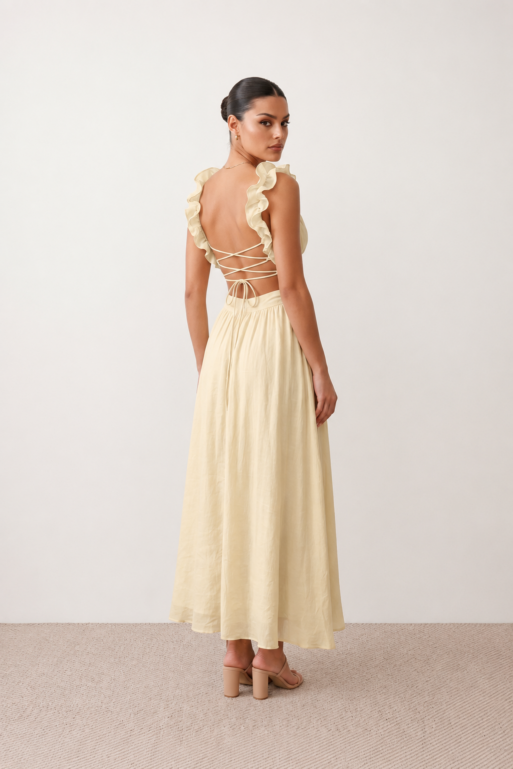 Woman wearing the Giedre Lace-Up A-Line Midi Dress featuring a deep V-neckline, ruffle shoulder sleeves, side waist cut-outs, adjustable lace-up open back and a flowing A-line midi skirt, ideal for weddings, race days and special occasions.