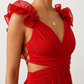 Woman wearing the Giedre Lace-Up A-Line Midi Dress featuring a deep V-neckline, ruffle shoulder sleeves, side waist cut-outs, adjustable lace-up open back and a flowing A-line midi skirt, ideal for weddings, race days and special occasions.
