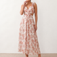 Woman wearing the Giedre Lace-Up A-Line Midi Dress featuring a deep V-neckline, ruffle shoulder sleeves, side waist cut-outs, adjustable lace-up open back and a flowing A-line midi skirt, ideal for weddings, race days and special occasions.