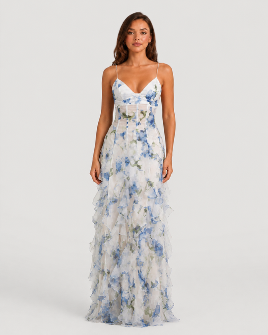 Women's floral ruffle maxi dress with corset-inspired bodice, adjustable straps, and flowing layered chiffon-look skirt in a feminine occasionwear silhouette.