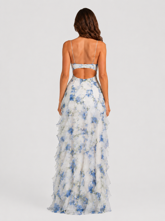 Women's floral ruffle maxi dress with corset-inspired bodice, adjustable straps, and flowing layered chiffon-look skirt in a feminine occasionwear silhouette.