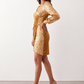 Women's Lidija sequined ruched mini dress with a wrap-style V-neckline, long sleeves, fitted silhouette, front ruching, asymmetric hem, and subtle front slit, ideal for parties, cocktail events, and festive occasions.