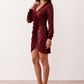 Women's Lidija sequined ruched mini dress with a wrap-style V-neckline, long sleeves, fitted silhouette, front ruching, asymmetric hem, and subtle front slit, ideal for parties, cocktail events, and festive occasions.