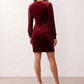 Women's Lidija sequined ruched mini dress with a wrap-style V-neckline, long sleeves, fitted silhouette, front ruching, asymmetric hem, and subtle front slit, ideal for parties, cocktail events, and festive occasions.