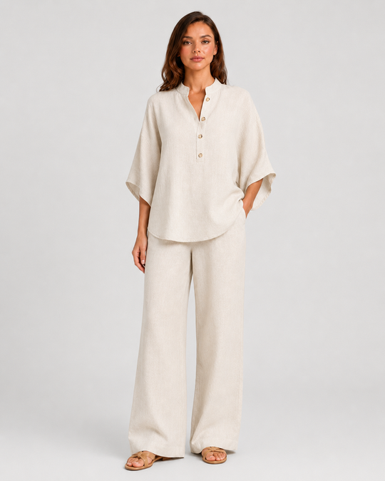Woman wearing a neutral linen blend two-piece set featuring a button-up shirt and relaxed wide-leg trousers, styled for effortless warm-weather elegance.