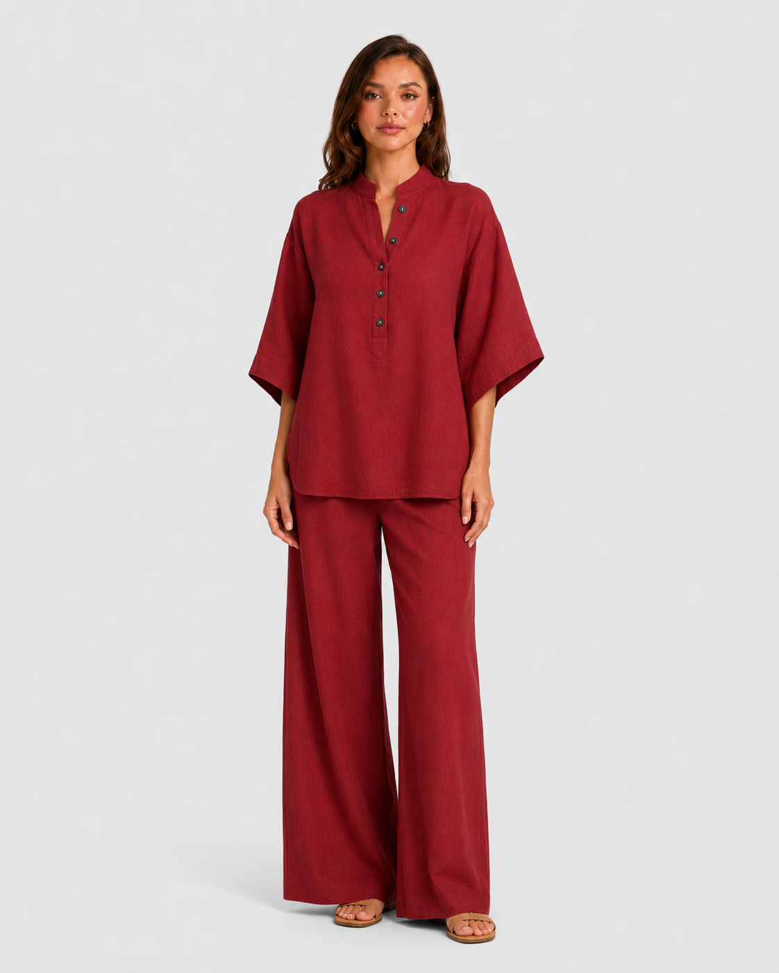 Woman wearing a neutral linen blend two-piece set featuring a button-up shirt and relaxed wide-leg trousers, styled for effortless warm-weather elegance.