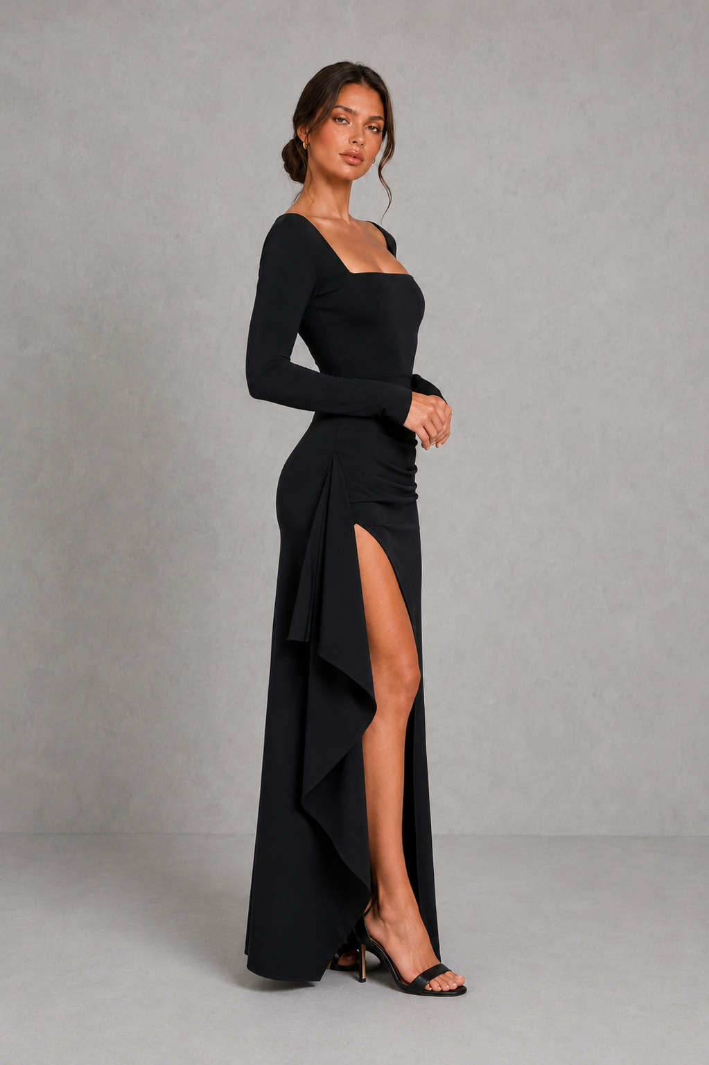 Women’s long sleeve stretch crepe maxi dress featuring a pleated waist, flared cuffs, fitted silhouette, and draped thigh-high split for evening and formal occasions.