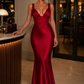 Women's satin maxi dress with a structured corset bodice, pleated cups, fan-shaped shoulder straps, adjustable lace-up back, and a flowing bias-cut skirt, designed for elegant evening occasions and formal events.