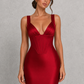 Women's satin maxi dress with a structured corset bodice, pleated cups, fan-shaped shoulder straps, adjustable lace-up back, and a flowing bias-cut skirt, designed for elegant evening occasions and formal events.