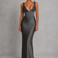 Women's satin maxi dress with a structured corset bodice, pleated cups, fan-shaped shoulder straps, adjustable lace-up back, and a flowing bias-cut skirt, designed for elegant evening occasions and formal events.