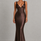 Women's satin maxi dress with a structured corset bodice, pleated cups, fan-shaped shoulder straps, adjustable lace-up back, and a flowing bias-cut skirt, designed for elegant evening occasions and formal events.