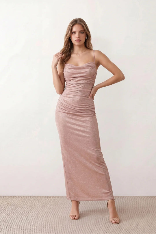 Woman wearing the metallic cowl neck mermaid maxi dress with adjustable spaghetti straps, a ruched bodice, low open back, and shimmering figure-hugging silhouette, perfect for weddings, black-tie events, proms, and formal evening occasions.