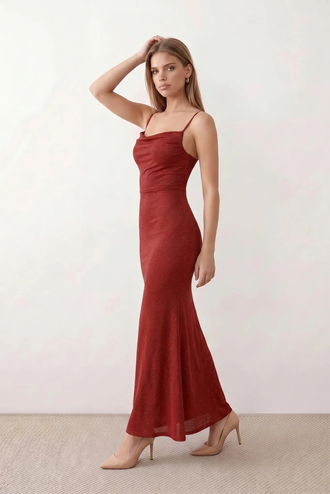Woman wearing the metallic cowl neck mermaid maxi dress with adjustable spaghetti straps, a ruched bodice, low open back, and shimmering figure-hugging silhouette, perfect for weddings, black-tie events, proms, and formal evening occasions.