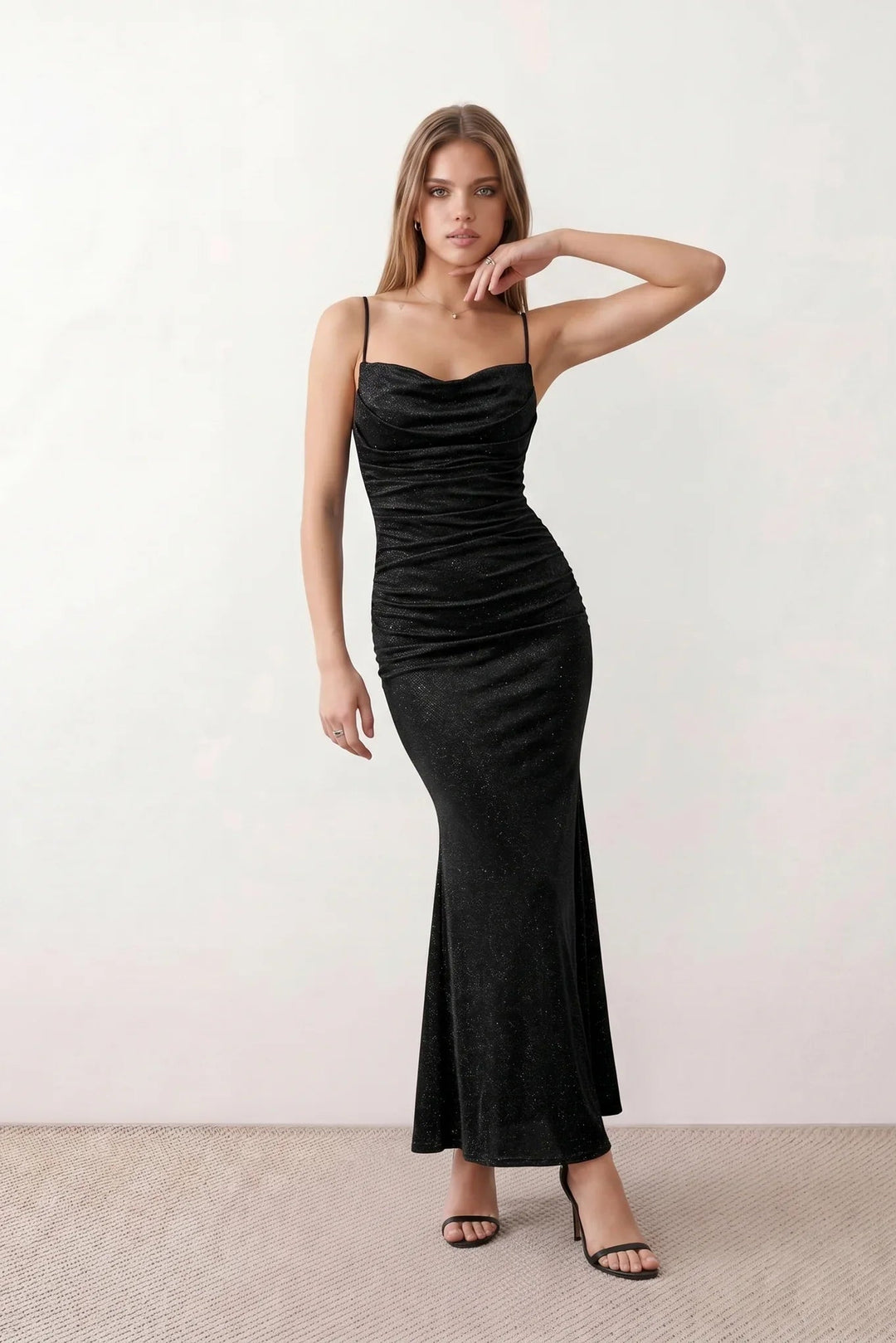 Woman wearing the metallic cowl neck mermaid maxi dress with adjustable spaghetti straps, a ruched bodice, low open back, and shimmering figure-hugging silhouette, perfect for weddings, black-tie events, proms, and formal evening occasions.
