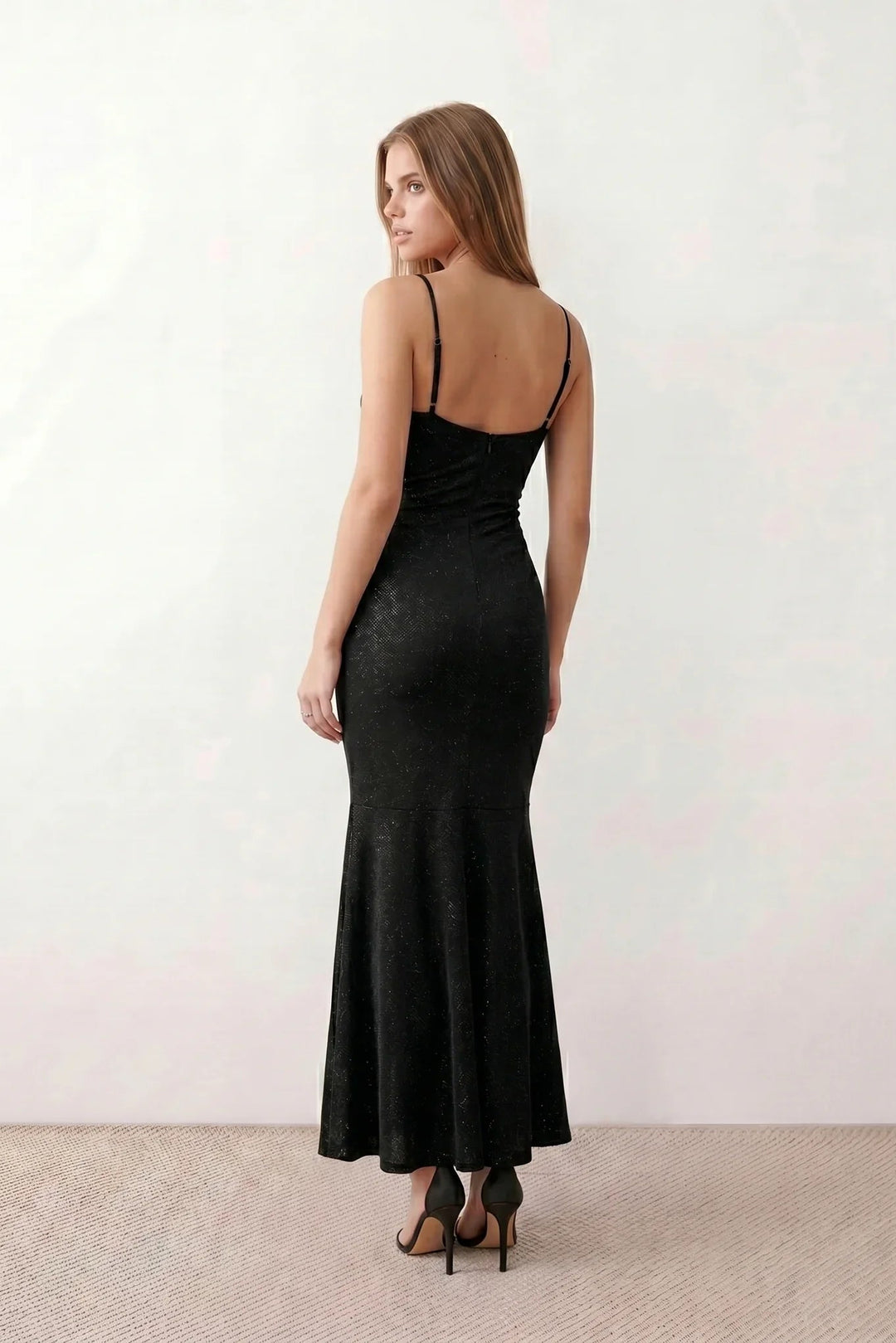 Woman wearing the metallic cowl neck mermaid maxi dress with adjustable spaghetti straps, a ruched bodice, low open back, and shimmering figure-hugging silhouette, perfect for weddings, black-tie events, proms, and formal evening occasions.