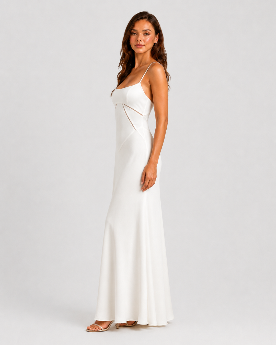 Woman wearing an elegant bustier maxi gown with delicate straps, fitted bodice, and flowing full-length skirt designed for formal occasions.