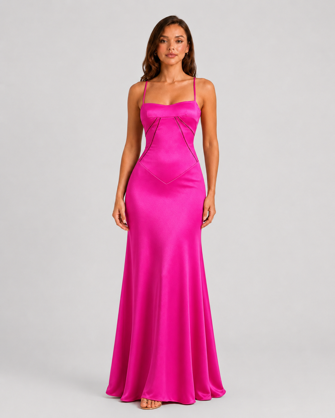 Woman wearing an elegant bustier maxi gown with delicate straps, fitted bodice, and flowing full-length skirt designed for formal occasions.