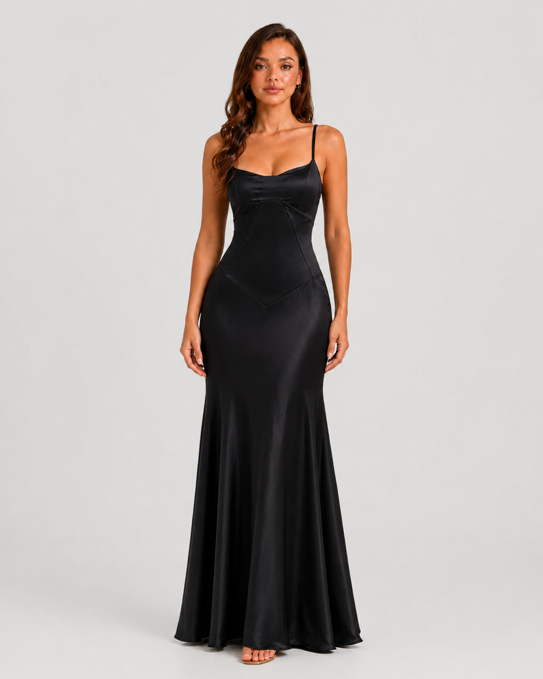 Woman wearing an elegant bustier maxi gown with delicate straps, fitted bodice, and flowing full-length skirt designed for formal occasions.