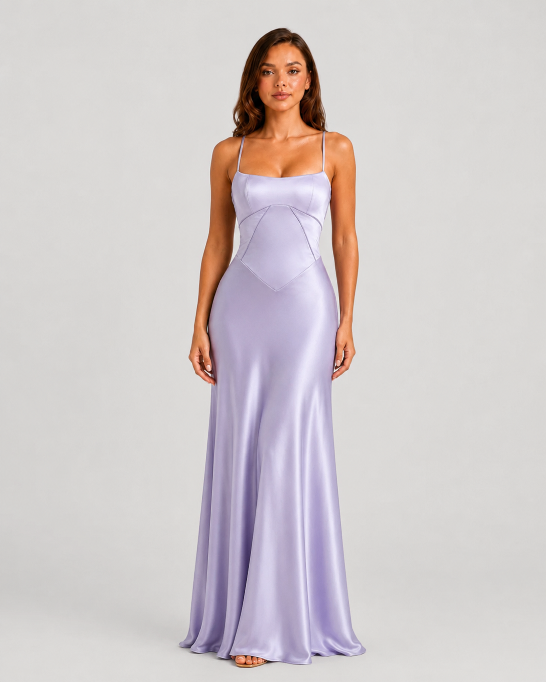 Woman wearing an elegant bustier maxi gown with delicate straps, fitted bodice, and flowing full-length skirt designed for formal occasions.