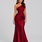 Woman wearing a one-shoulder satin maxi dress with a fitted stretch crepe bodice, asymmetric dropped waist, and elegant draped hip detailing.
