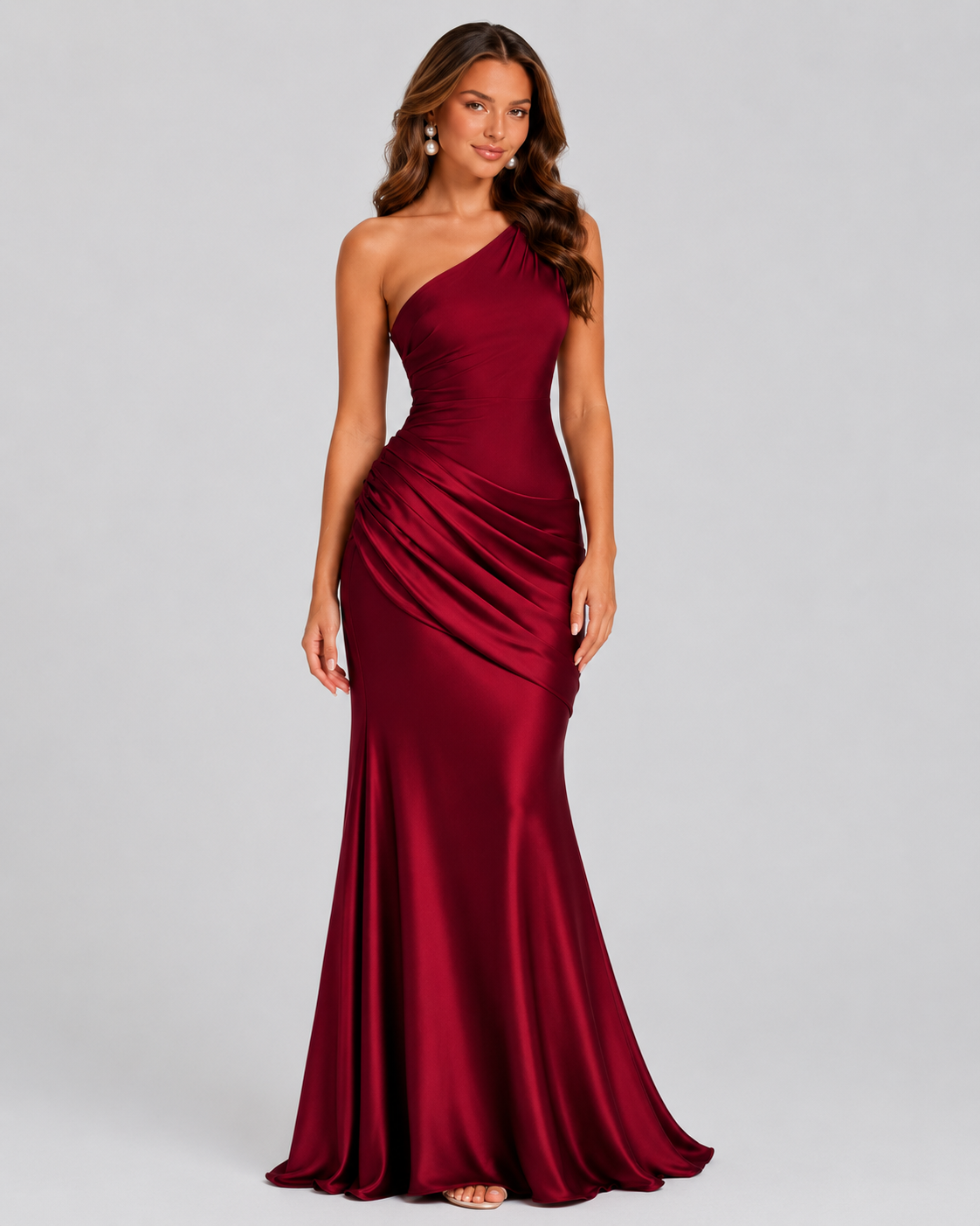Woman wearing a one-shoulder satin maxi dress with a fitted stretch crepe bodice, asymmetric dropped waist, and elegant draped hip detailing.