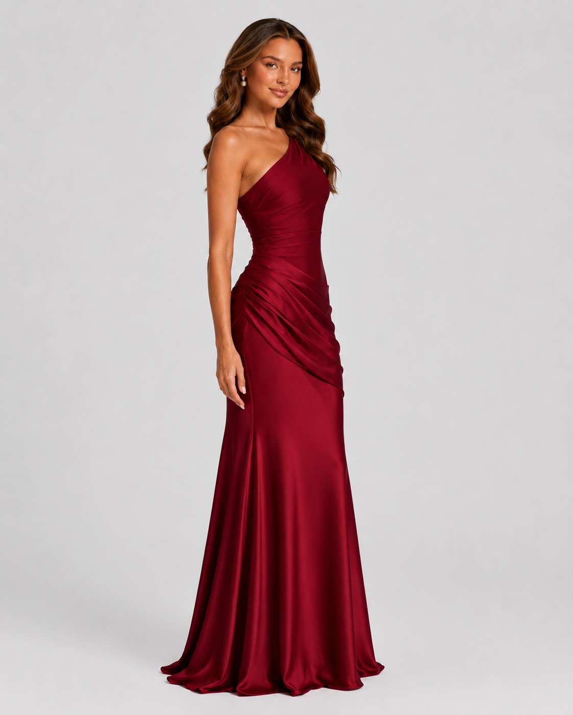 Woman wearing a one-shoulder satin maxi dress with a fitted stretch crepe bodice, asymmetric dropped waist, and elegant draped hip detailing.