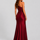 Woman wearing a one-shoulder satin maxi dress with a fitted stretch crepe bodice, asymmetric dropped waist, and elegant draped hip detailing.