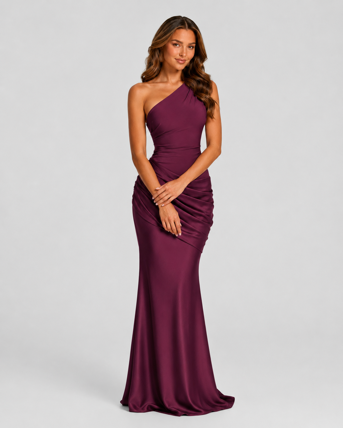 Woman wearing a one-shoulder satin maxi dress with a fitted stretch crepe bodice, asymmetric dropped waist, and elegant draped hip detailing.