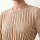 Woman wearing the Pleated Ruffle Detail Mini Dress featuring an all-over pleated design, flowing bell sleeves, a round neckline, elasticated waist with a self-tie sash, and a feminine ruffle hem, perfect for weddings, garden parties, race days, and elegant occasions.