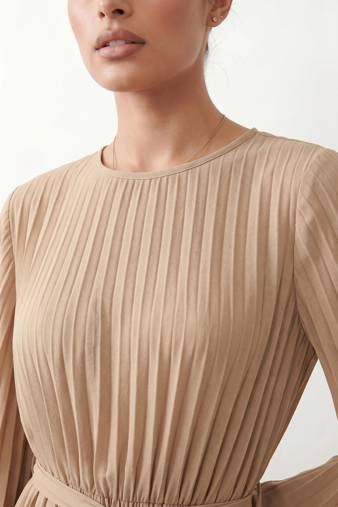 Woman wearing the Pleated Ruffle Detail Mini Dress featuring an all-over pleated design, flowing bell sleeves, a round neckline, elasticated waist with a self-tie sash, and a feminine ruffle hem, perfect for weddings, garden parties, race days, and elegant occasions.