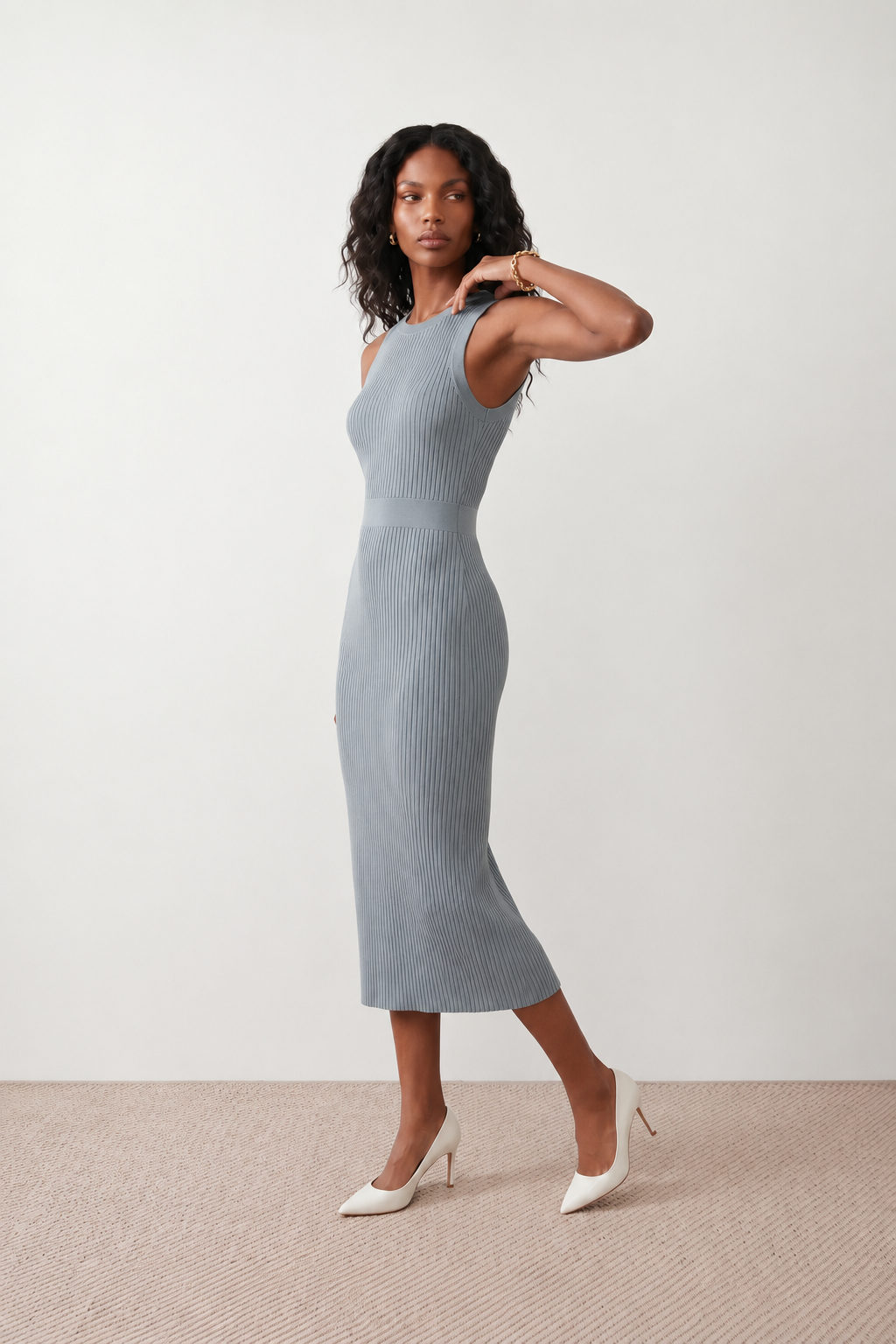 Woman wearing the Raina ribbed fitted midi dress in a sleeveless bodycon design with a round neckline, wide-rib knit texture and elegant side slit, styled as a sophisticated occasion dress.