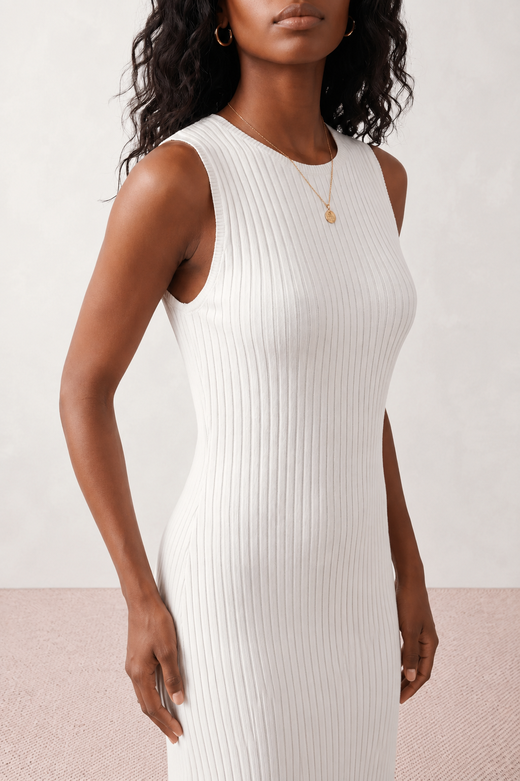 Woman wearing the Raina ribbed fitted midi dress in a sleeveless bodycon design with a round neckline, wide-rib knit texture and elegant side slit, styled as a sophisticated occasion dress.