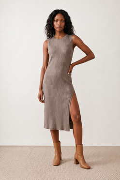 Woman wearing the Raina ribbed fitted midi dress in a sleeveless bodycon design with a round neckline, wide-rib knit texture and elegant side slit, styled as a sophisticated occasion dress.