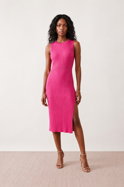 Woman wearing the Raina ribbed fitted midi dress in a sleeveless bodycon design with a round neckline, wide-rib knit texture and elegant side slit, styled as a sophisticated occasion dress.