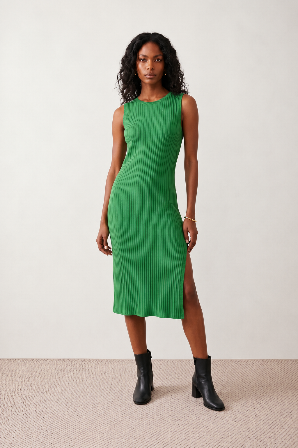 Woman wearing the Raina ribbed fitted midi dress in a sleeveless bodycon design with a round neckline, wide-rib knit texture and elegant side slit, styled as a sophisticated occasion dress.