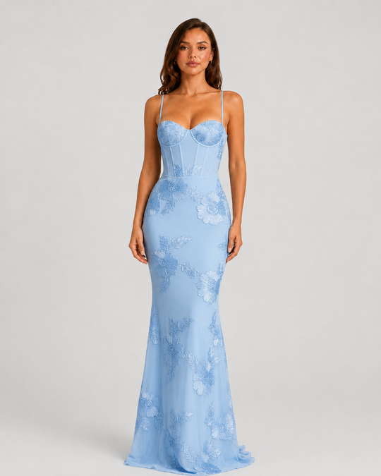 Woman wearing a floral embroidered corset maxi dress with delicate straps and a flowing full-length skirt, styled for weddings and formal occasions.